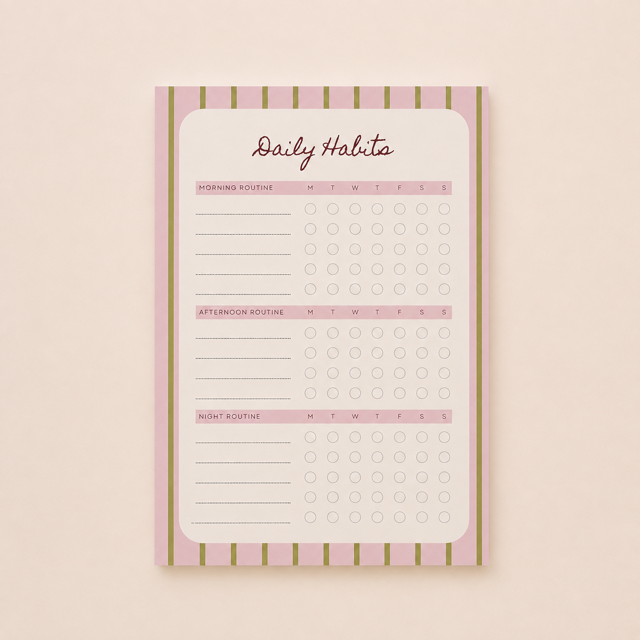 A hand holding a pen writes on a 'TODAYS PLANS' notepad, placed on a light beige surface next to a pink glass dish with gold paperclips.