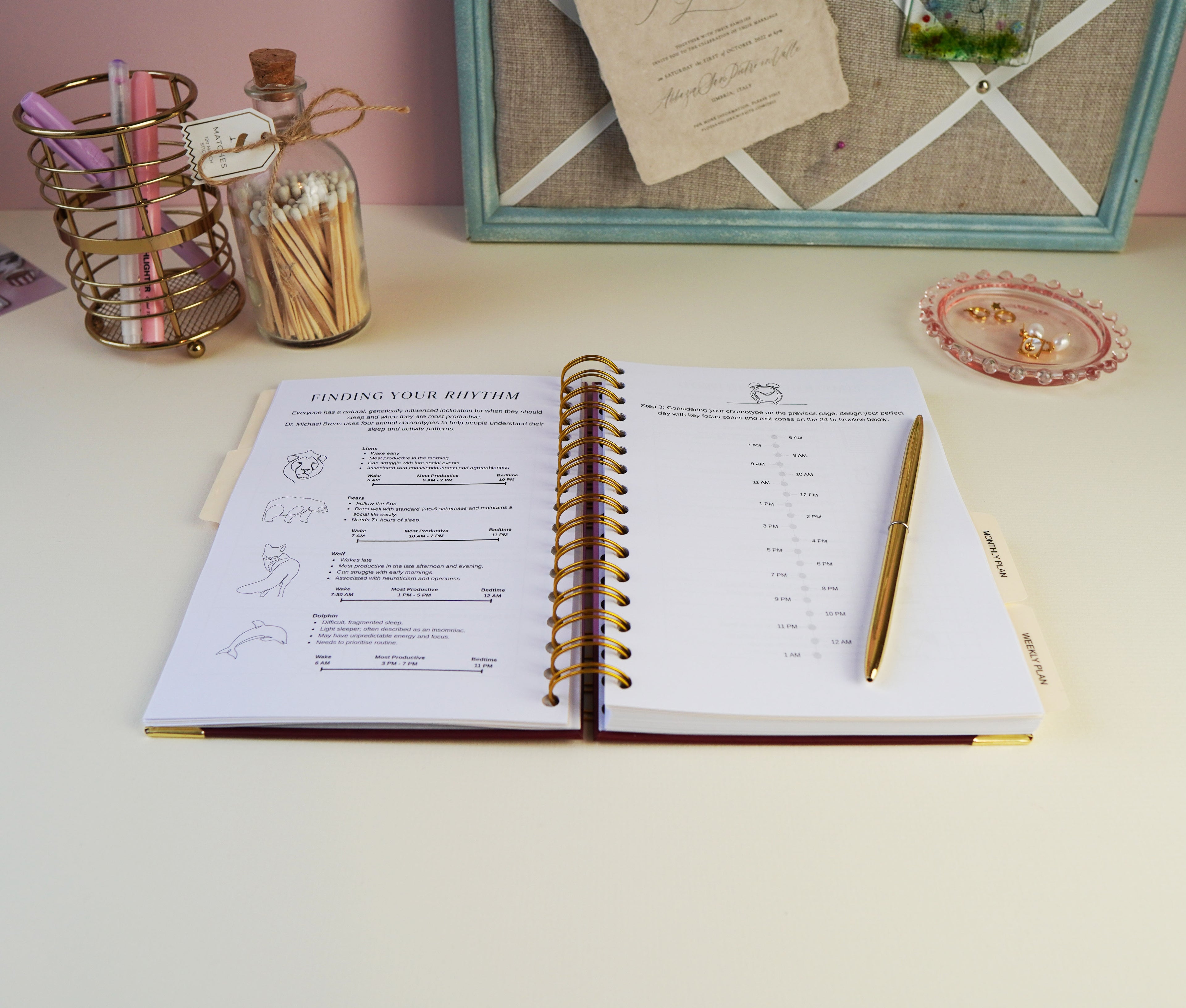 Open spiral-bound notebook on a desk with stationery items in the background